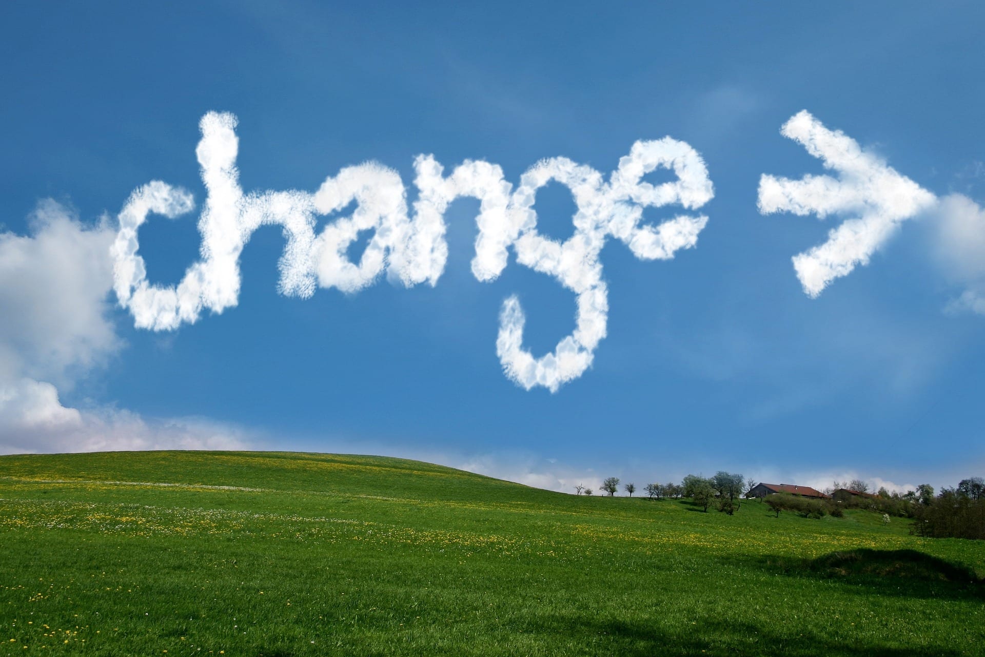A landscape with the word "CHANGE," along with an arrow pointing to the right, written in the clouds.